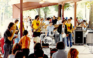 George Makrauer playing drums with co-workers band for summer picnic